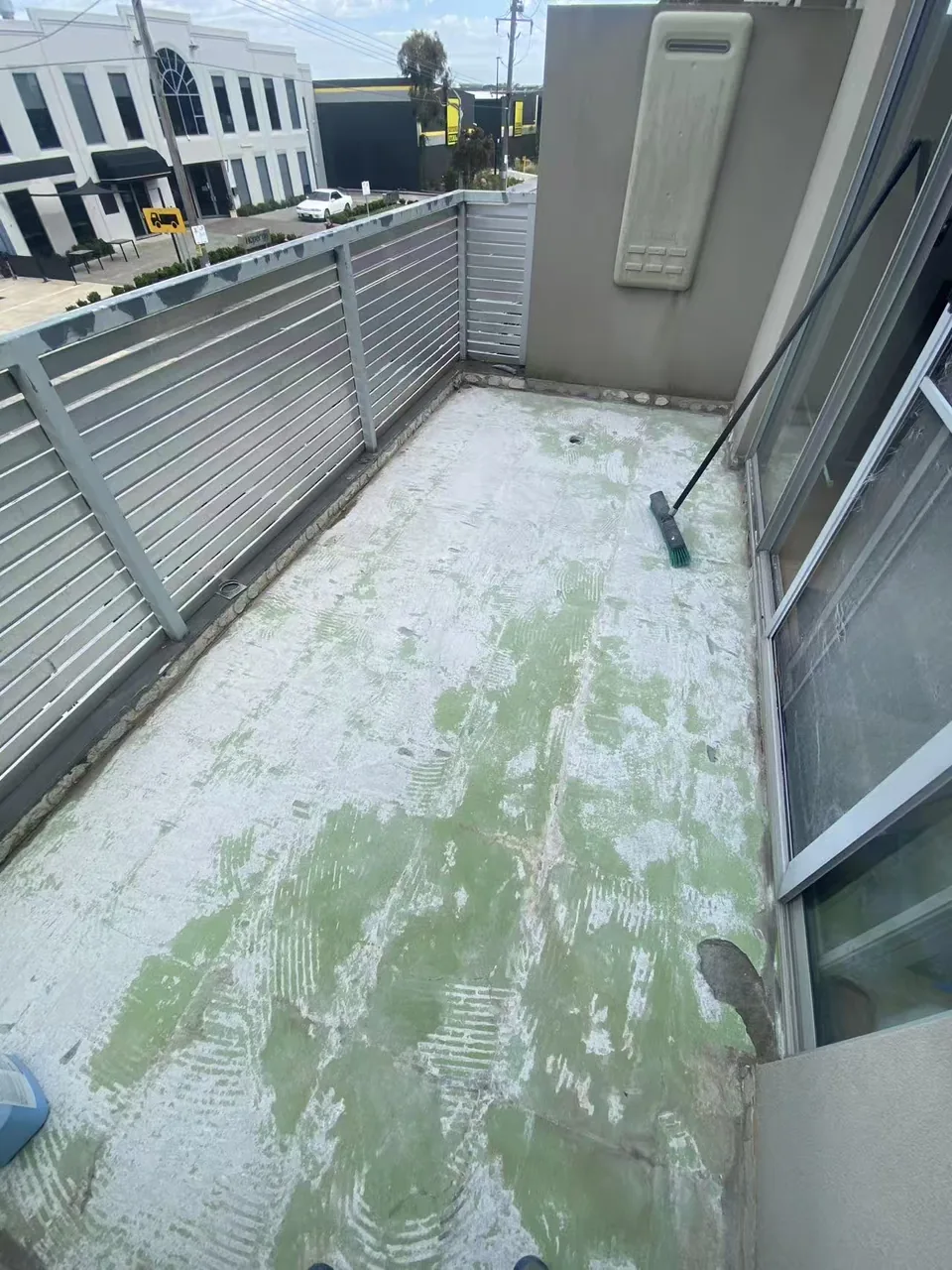 Prepared balcony floor with the existing surface cleaned back before waterproofing