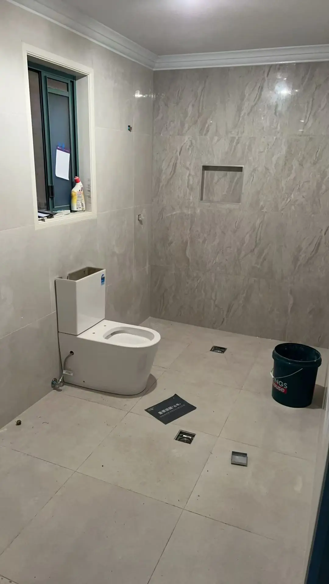 Toilet installed in a newly tiled bathroom before final fit-out